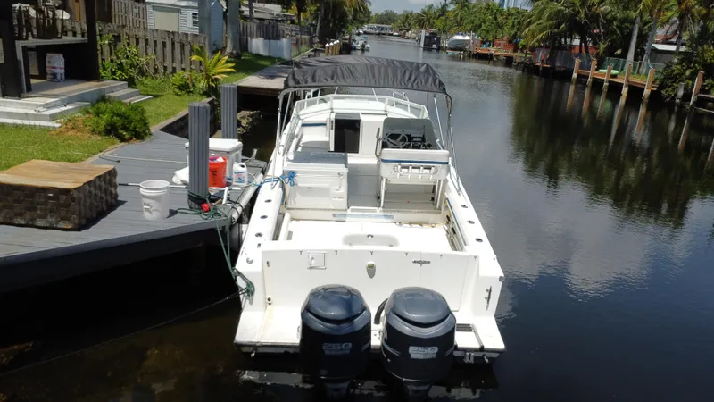 Slide: The Image of 2000 Contender 35 Side Console boat docked on a calm canal. - 5