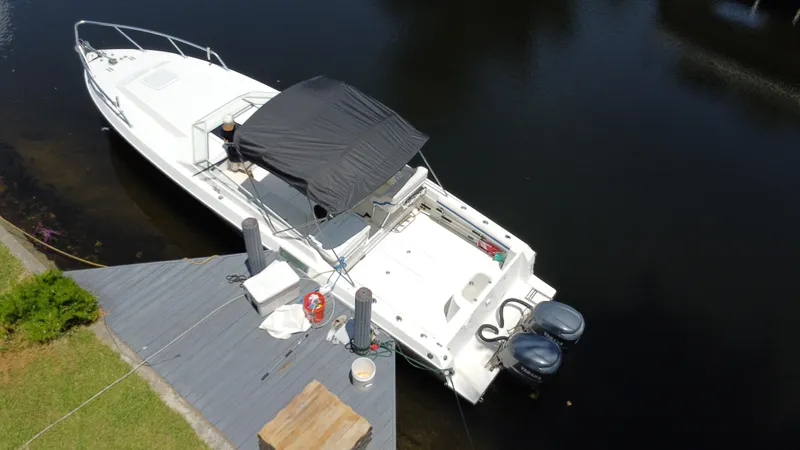 Slide: The Image of Aerial view of 2000 Contender 35 Side Console boat docked by the water. - 7