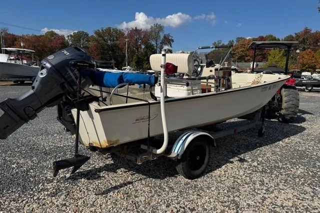 Slide: The Image of 1973 Boston Whaler 17 Montauk boat on trailer, parked on gravel lot. - 3