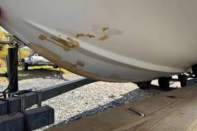 Slide: The Image of 1973 Boston Whaler 17 Montauk boat hull with visible wear on trailer. - 4