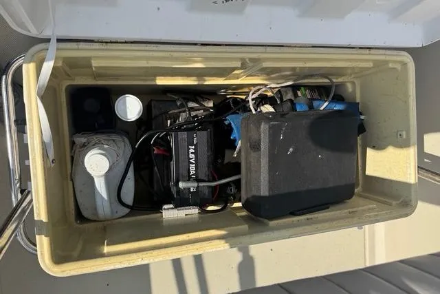 Slide: The Image of 1973 Boston Whaler 17 Montauk boat storage compartment with battery and equipment. - 7