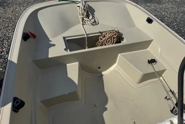 Slide: The Image of 1973 Boston Whaler 17 Montauk boat interior with rope and storage compartment. - 8