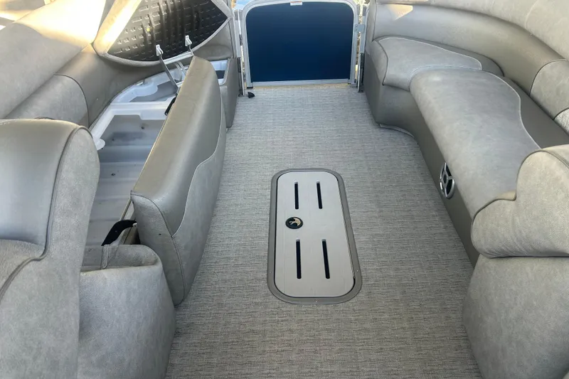 Slide: The Image of 2019 Premier 240 SunSation pontoon boat interior with plush seating and table. - 18