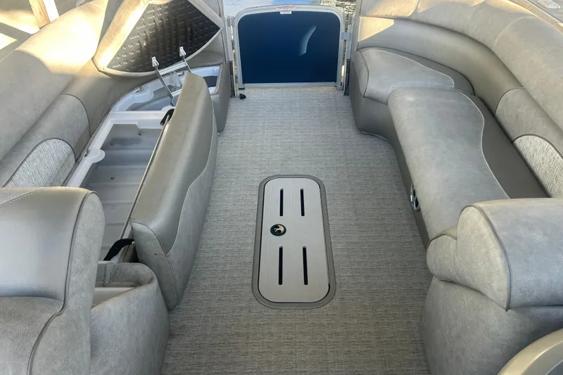 Slide: The Image of 2019 Premier 240 SunSation boat interior with gray seating and cupholder table. - 20