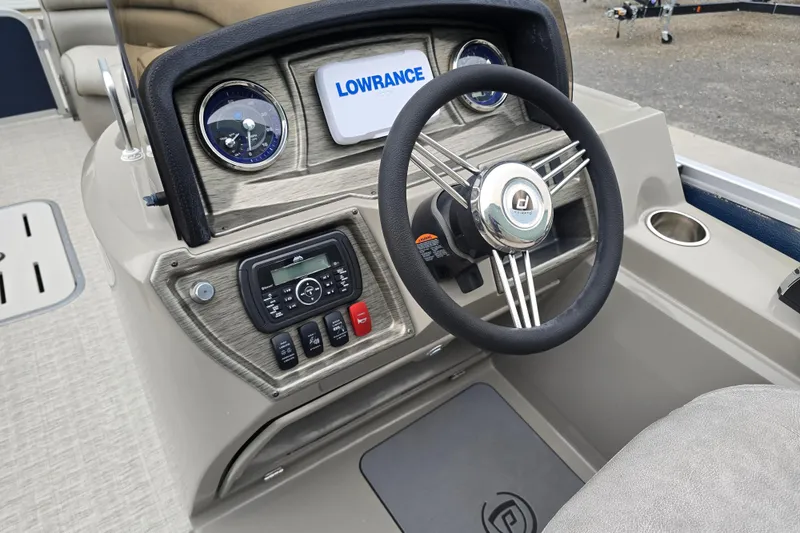 Slide: The Image of 2019 Premier 240 SunSation boat dashboard with steering wheel and Lowrance display. - 25