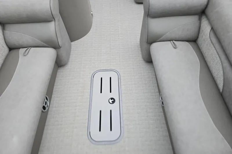 Slide: The Image of 2019 Premier 240 SunSation boat interior with gray seating and floor storage compartment. - 32