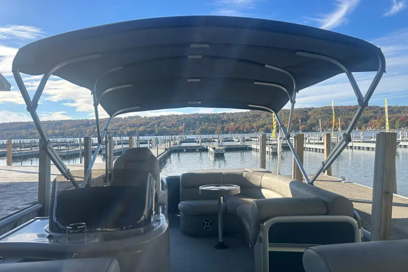 Slide: The Image of 2019 Premier 240 SunSation pontoon boat docked at scenic marina. - 38