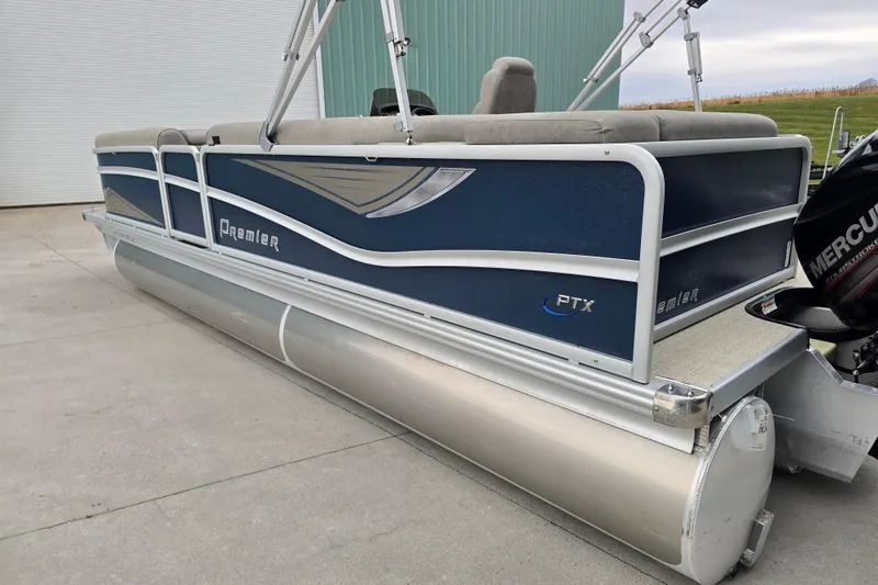 Slide: The Image of 2019 Premier 240 SunSation pontoon boat with Mercury engine, parked on concrete surface. - 4