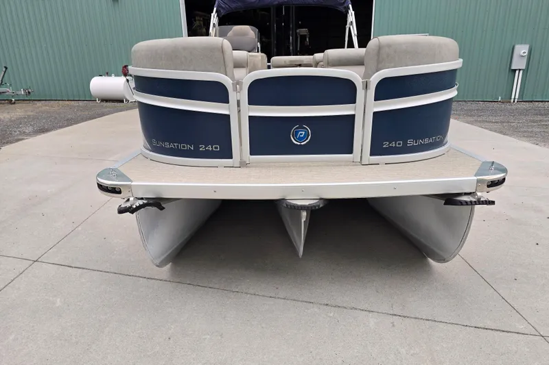 Slide: The Image of 2019 Premier 240 SunSation pontoon boat, rear view, parked on concrete surface. - 5