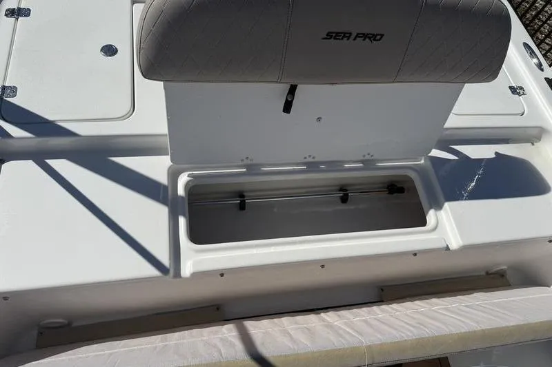 Slide: The Image of 2021 Sea Pro 172 Bay boat with open storage compartment and cushioned seat. - 10