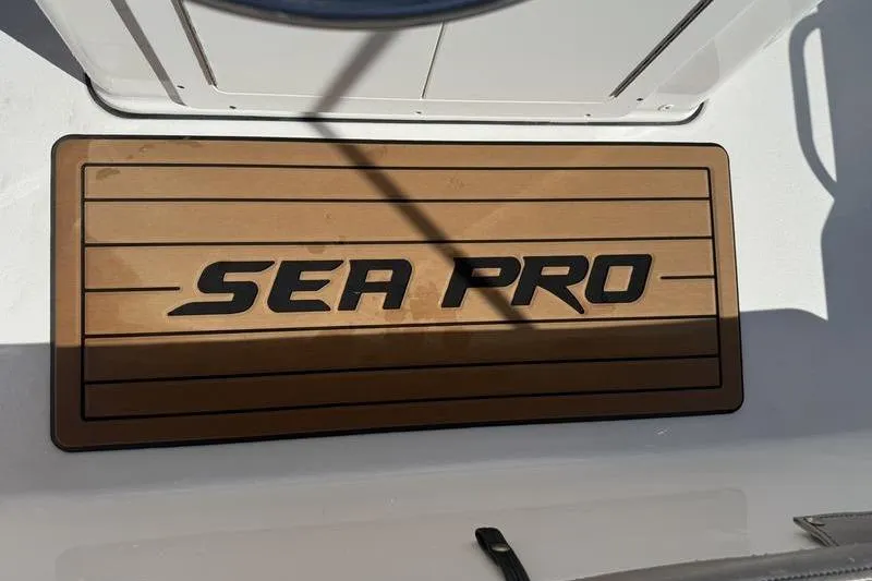 Slide: The Image of Sea Pro 172 Bay 2021 boat deck with logo, featuring wood-like finish. - 8