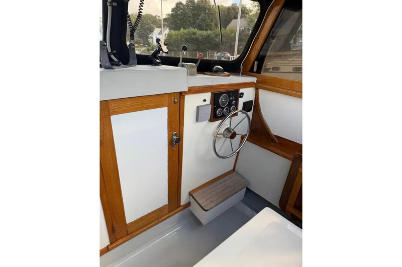 Slide: The Image of 1980 GROVER BUILT 26 Diesel boat interior with wooden accents and steering wheel. - 6