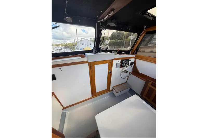 Slide: The Image of 1980 GROVER BUILT 26 Diesel boat interior with wooden accents and steering wheel. - 7