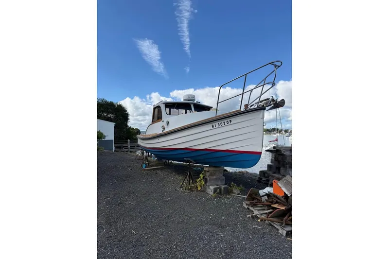 Slide: The Image of 1980 GROVER BUILT 26 Diesel boat on land, blue sky background. - 9