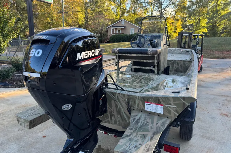 Slide: The Image of 2026 Crestliner 1860 Retriever CC boat with Mercury 90 engine, camo design. - 7