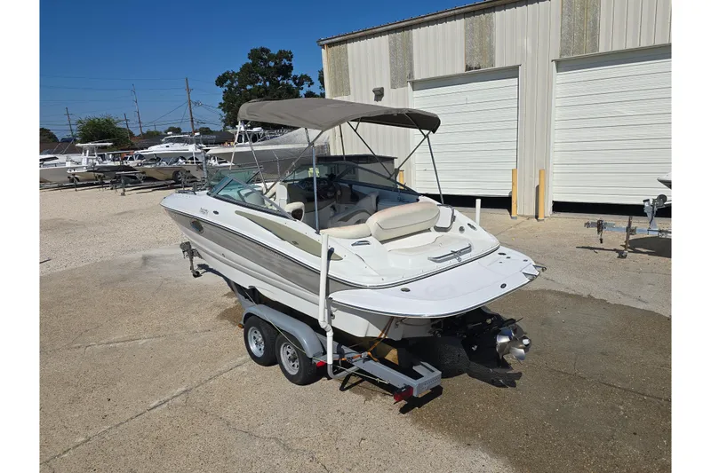 Slide: The Image of 2007 Crownline 220 LS boat on trailer, parked outside a storage facility. - 10