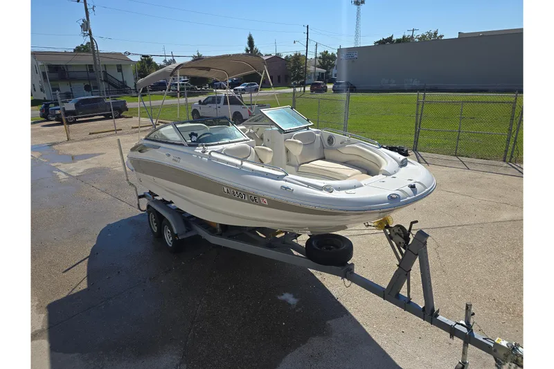 Slide: The Image of 2007 Crownline 220 LS boat on trailer in sunny outdoor setting. - 2