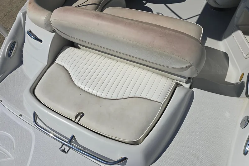 Slide: The Image of 2007 Crownline 220 LS boat interior seating, featuring white and beige upholstery. - 6