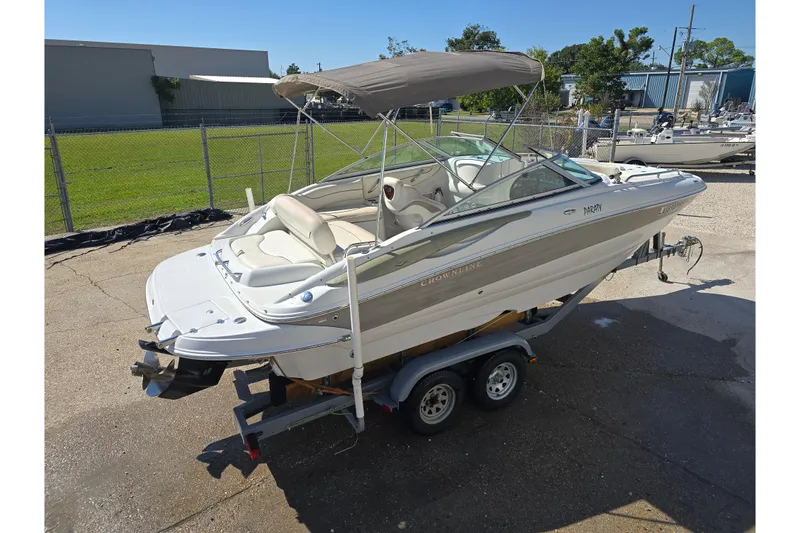 Slide: The Image of 2007 Crownline 220 LS boat on trailer with canopy, parked outdoors. - 8