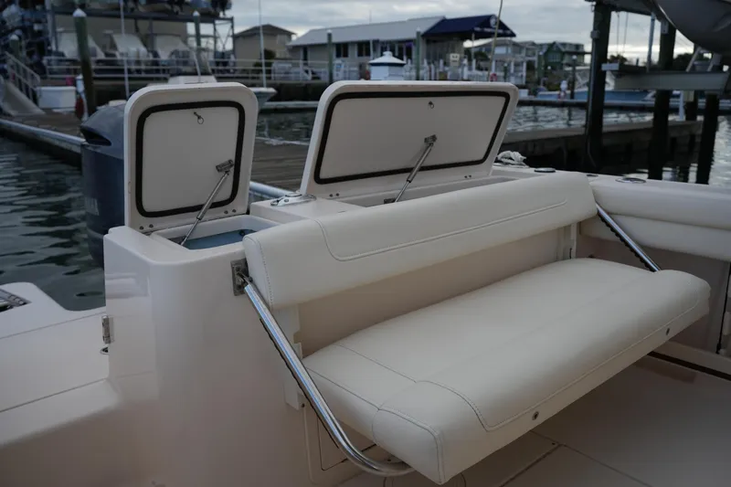 Slide: The Image of 2020 Grady-White Fisherman 236 boat with open storage compartments and cushioned seating. - 21