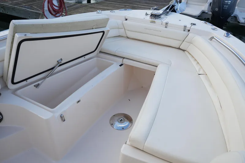 Slide: The Image of 2020 Grady-White Fisherman 236 boat with open storage compartment and cushioned seating. - 39