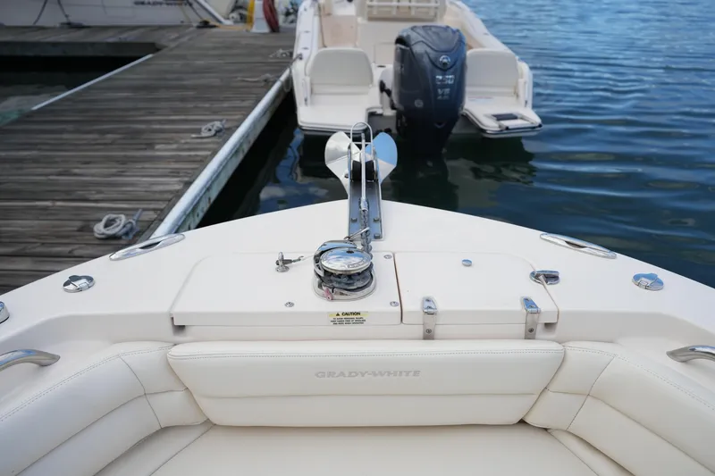 Slide: The Image of 2020 Grady-White Fisherman 236 boat docked, featuring a clean deck and outboard motor. - 41