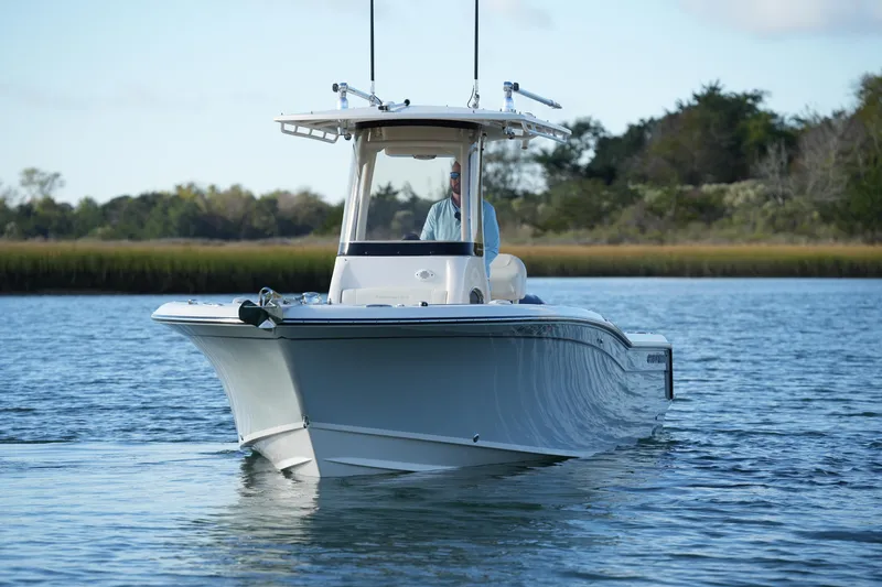 Slide: The Image of 2020 Grady-White Fisherman 236 boat cruising on calm water, surrounded by lush greenery. - 8