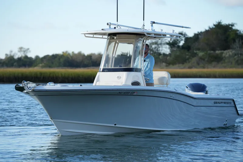 Slide: The Image of 2020 Grady-White Fisherman 236 boat on calm water, with a person at the helm. - 9