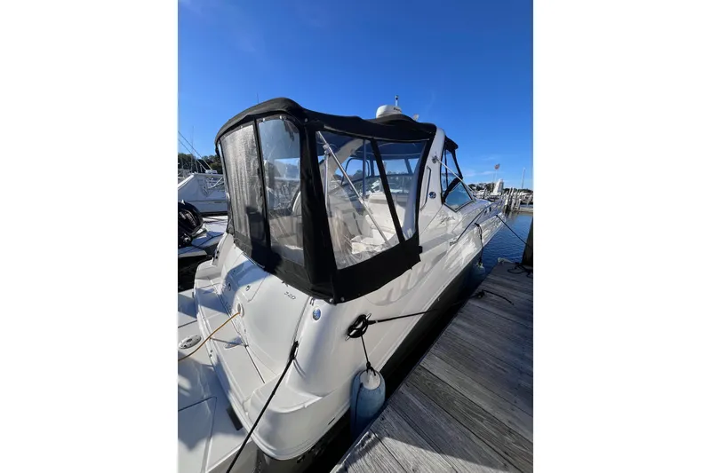 Slide: The Image of 2006 Sea Ray 320 Sundancer docked at marina under clear blue sky. - 10