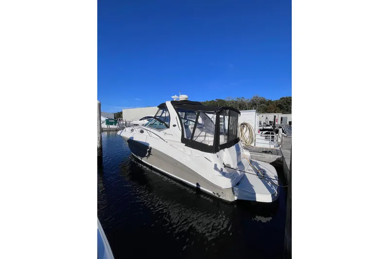 Slide: The Image of 2006 Sea Ray 320 Sundancer docked at marina under clear blue sky. - 12