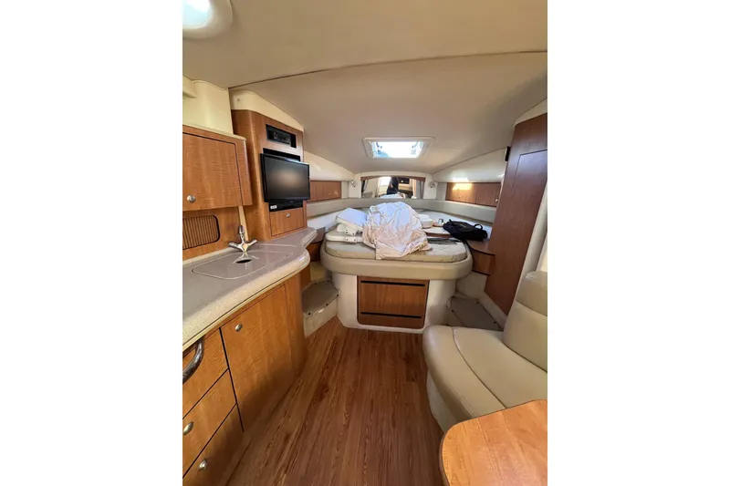 Slide: The Image of Interior of 2006 Sea Ray 320 Sundancer yacht with cozy seating and modern amenities. - 2