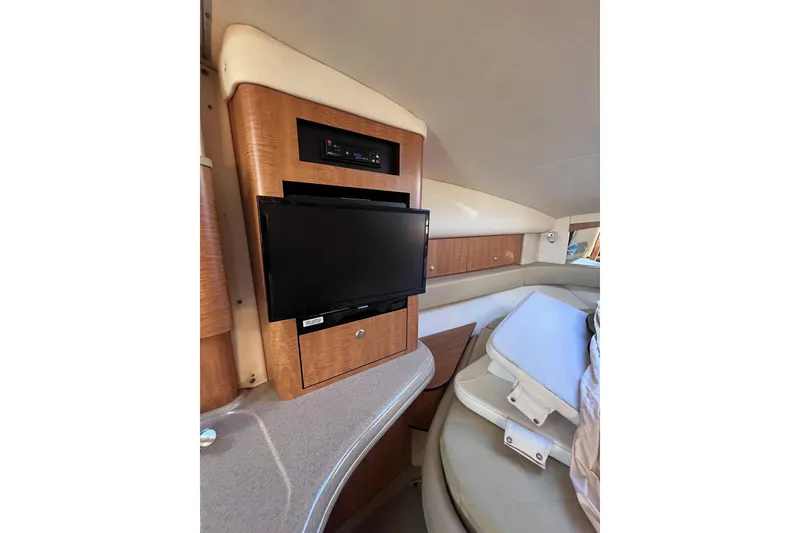 Slide: The Image of 2006 Sea Ray 320 Sundancer cabin interior with TV and seating area. - 3