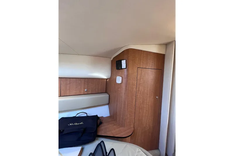 Slide: The Image of Interior of 2006 Sea Ray 320 Sundancer yacht with wood paneling and storage. - 4