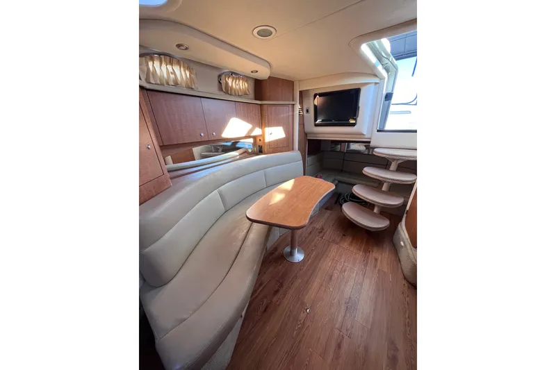 Slide: The Image of Interior of 2006 Sea Ray 320 Sundancer with seating, table, and TV. - 6