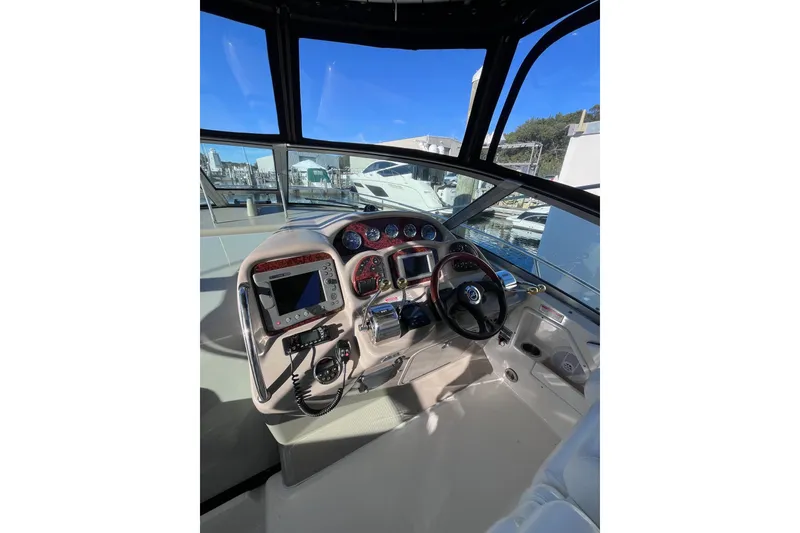Slide: The Image of Helm of 2006 Sea Ray 320 Sundancer with navigation instruments and steering wheel. - 7