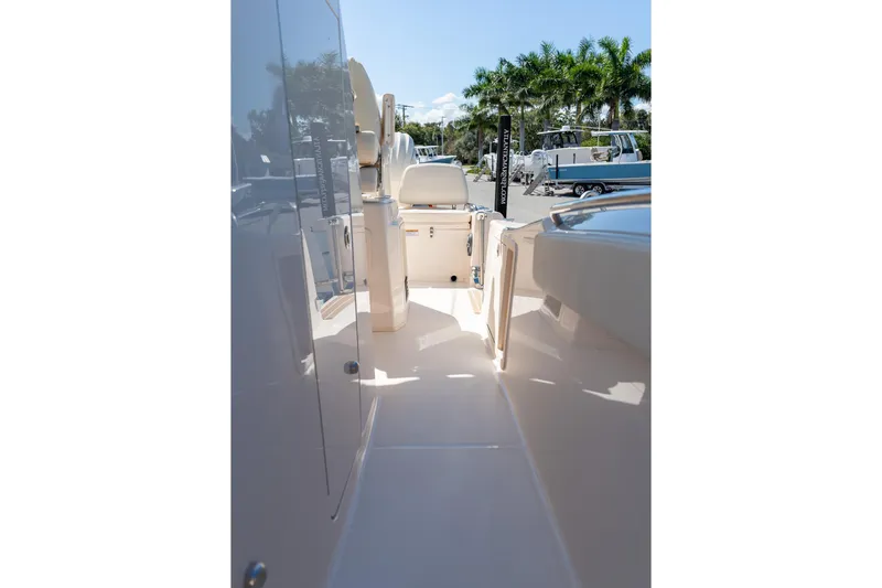 Slide: The Image of 2026 Grady-White 281 Coastal Explorer boat interior with seating and sunny deck view. - 11
