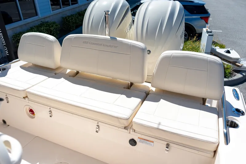 Slide: The Image of 2026 Grady-White 281 Coastal Explorer boat seating with dual engines in a parking area. - 21
