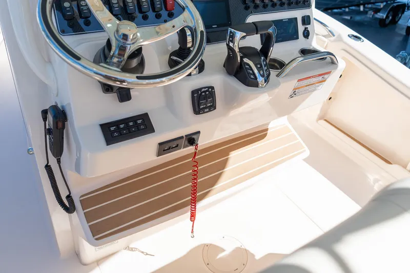 Slide: The Image of 2026 Grady-White 281 Coastal Explorer boat helm with steering wheel and controls. - 34