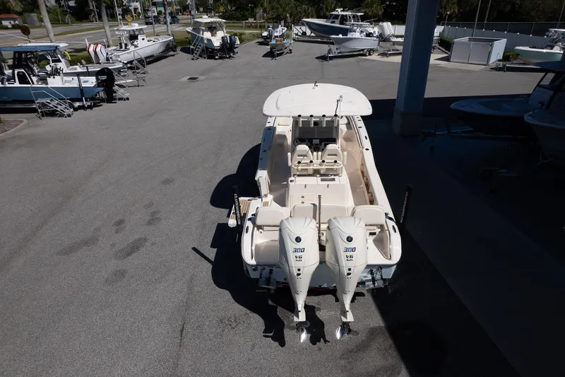 Slide: The Image of 2026 Grady-White 281 Coastal Explorer boat with dual 300 V6 engines, parked outdoors. - 4