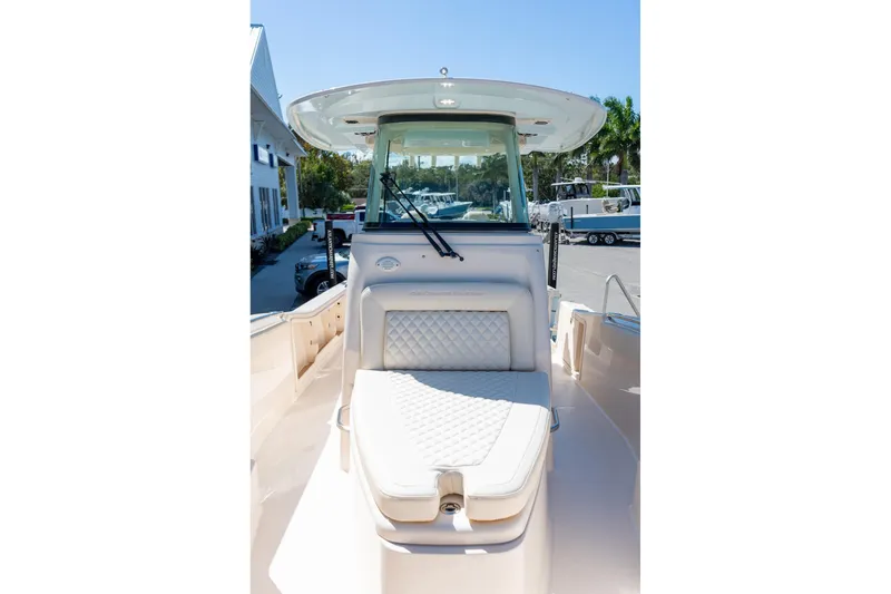 Slide: The Image of 2026 Grady-White 281 Coastal Explorer boat interior with cushioned seating and helm. - 44