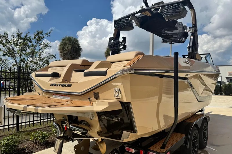 Slide: The Image of 2026 Nautique Super Air Nautique G23 Paragon boat, beige exterior, parked outdoors. - 3