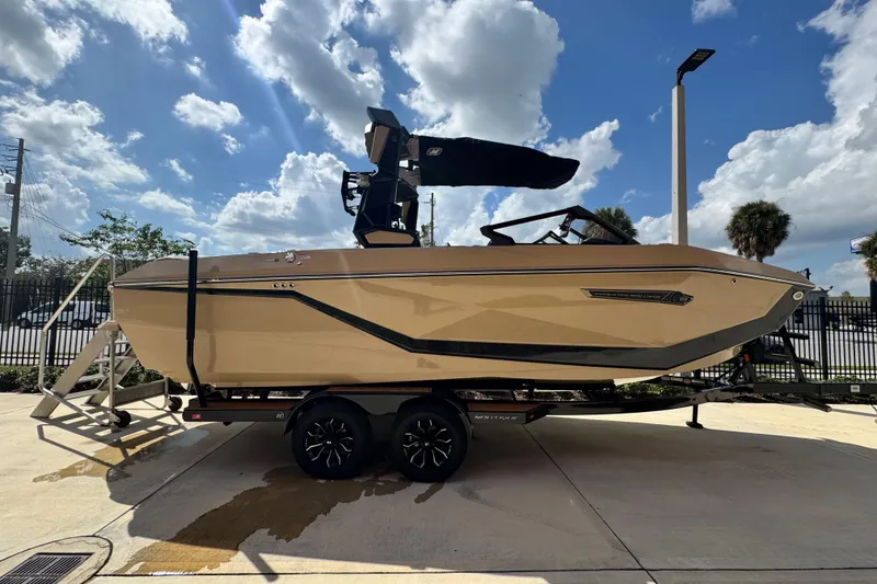 Slide: The Image of 2026 Nautique Super Air Nautique G23 Paragon boat on trailer under a blue sky. - 4