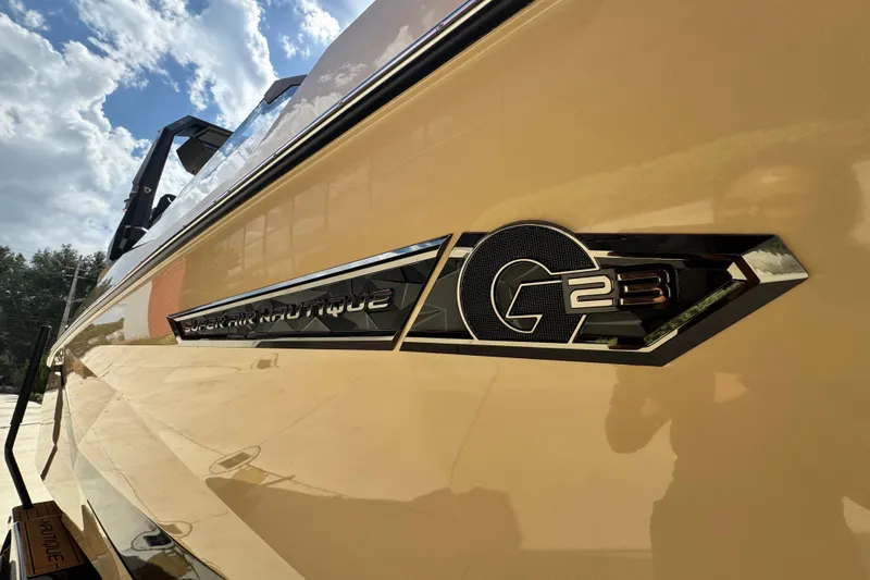 Slide: The Image of 2026 Nautique Super Air Nautique G23 Paragon side view with logo detail. - 6