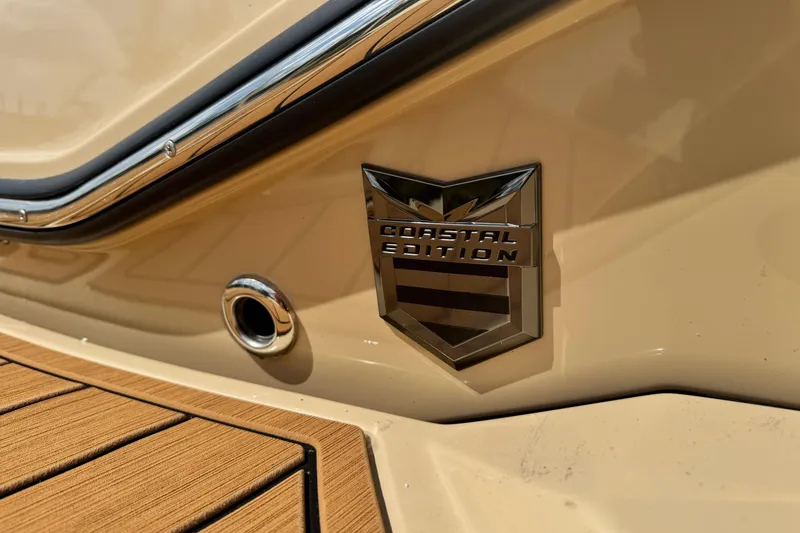 Slide: The Image of 2026 Nautique Super Air Nautique G23 Paragon Coastal Edition badge on beige exterior. - 7