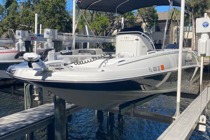 The Image of 2021 Tahoe 2150 CC boat docked with Minn Kota trolling motor. - 1
