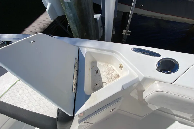 Slide: The Image of Open storage compartment on 2021 Tahoe 2150 CC boat, near dock. - 15