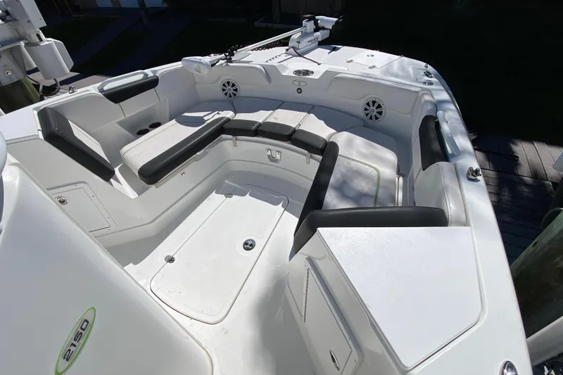 Slide: The Image of 2021 Tahoe 2150 CC boat interior with cushioned seating and storage compartments. - 16
