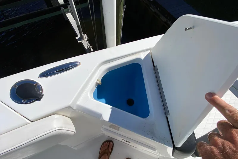 Slide: The Image of 2021 Tahoe 2150 CC boat with open storage compartment and blue interior. - 19