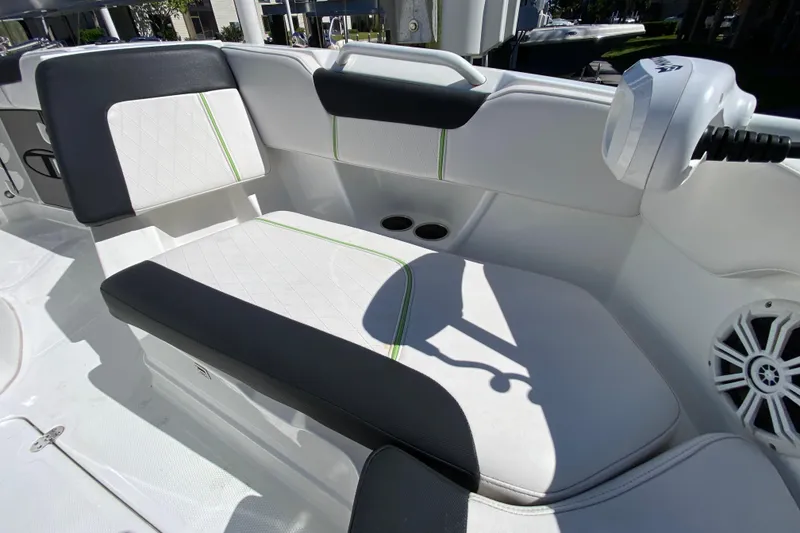 Slide: The Image of 2021 Tahoe 2150 CC boat interior with cushioned seating and speaker. - 24