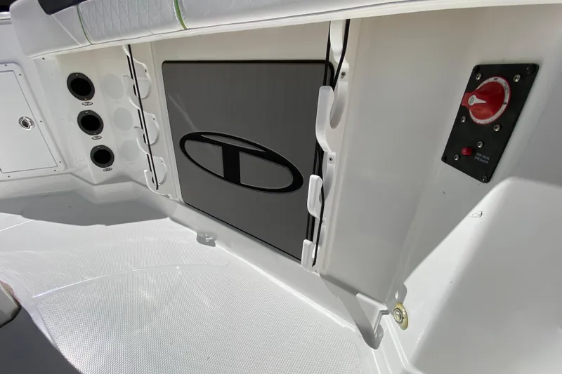 Slide: The Image of 2021 Tahoe 2150 CC boat interior with storage compartment and control panel. - 3